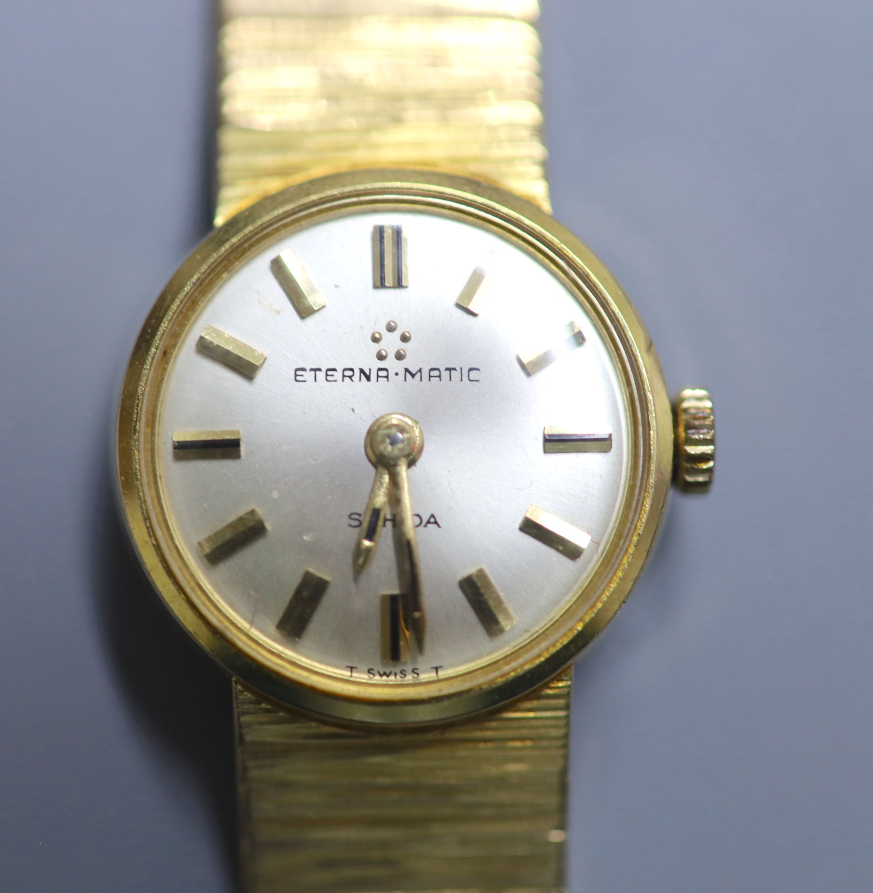 A ladys 9ct gold Eterna-Matic manual wind wrist watch, on a 9ct gold bracelet, overall 16cm, gross 30.7 grams.